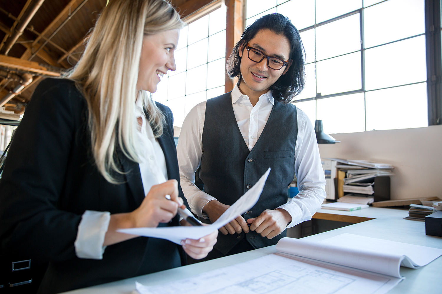 Cheerful coworkers analyze paperwork data research analytics and